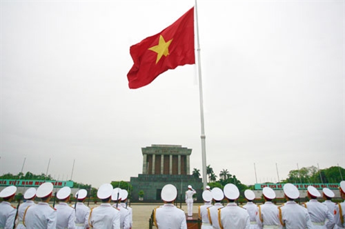 Proud flag salute at Uncle Ho Mausoleum